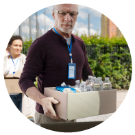 Person Holding Box Of Water Bottles Photo