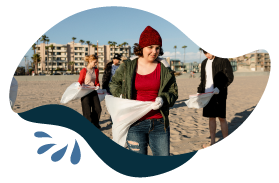 People Picking Trash Up On Beach Photo