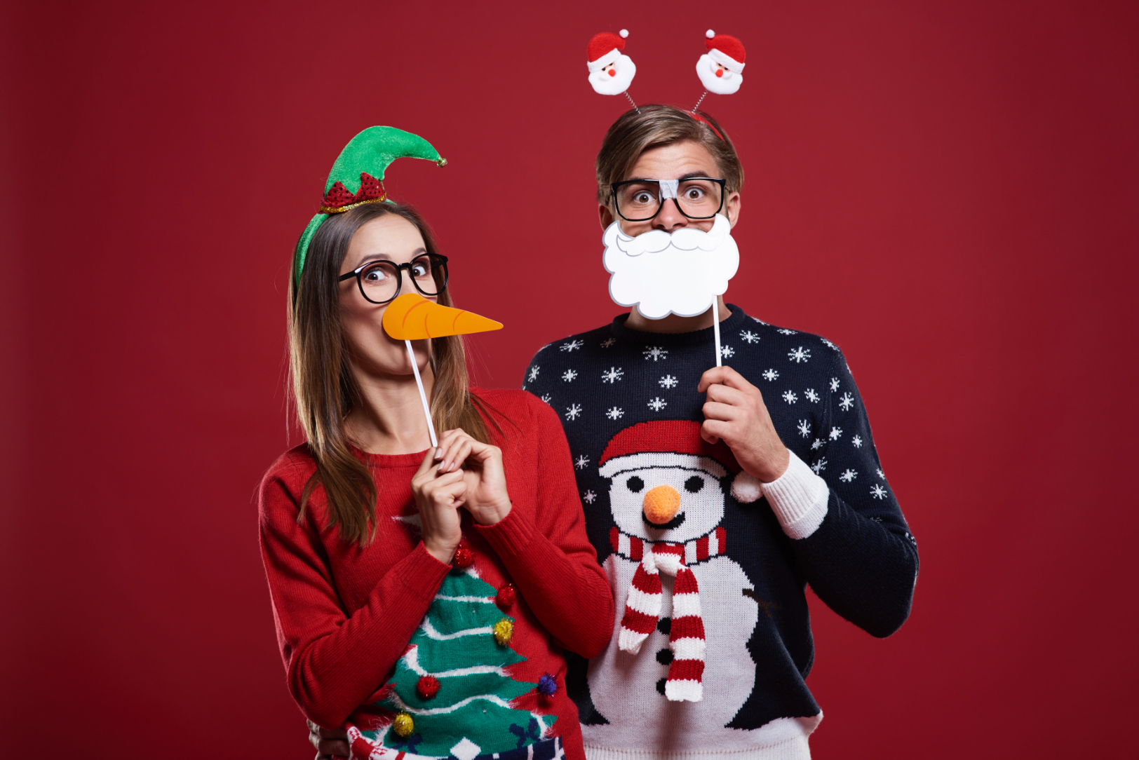 Funny couple wearing ugly christmas sweaters