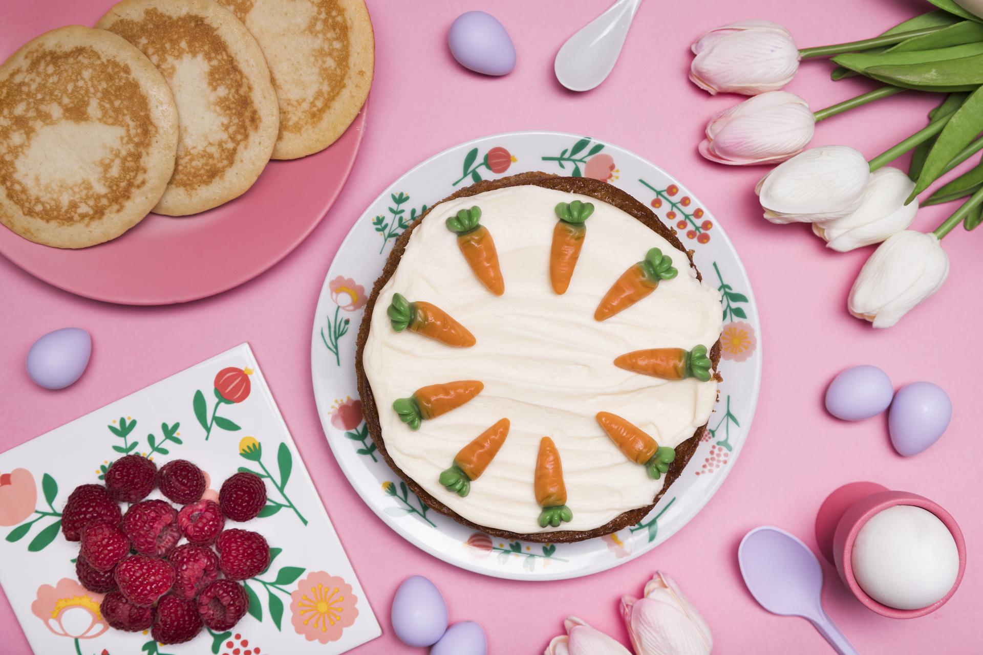 Top view of a cake with carrots and some pancakes