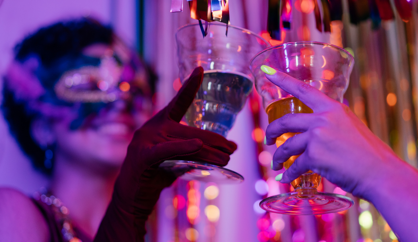 Mardi Gras image of two girls holding cocktails